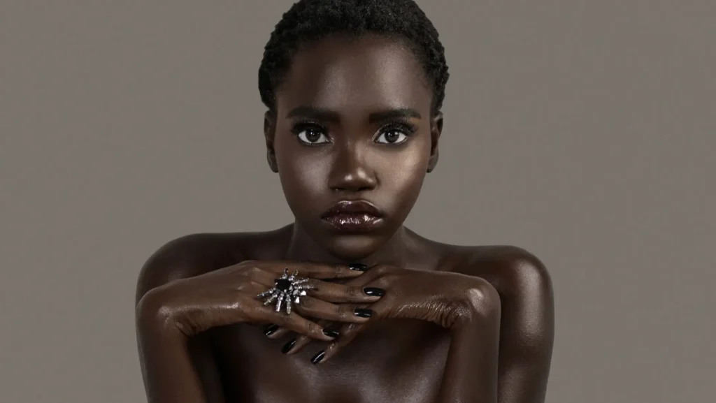 Beauty editorial creative direction portrait of Gaelle Augustin with sculptural hands against a neutral background
