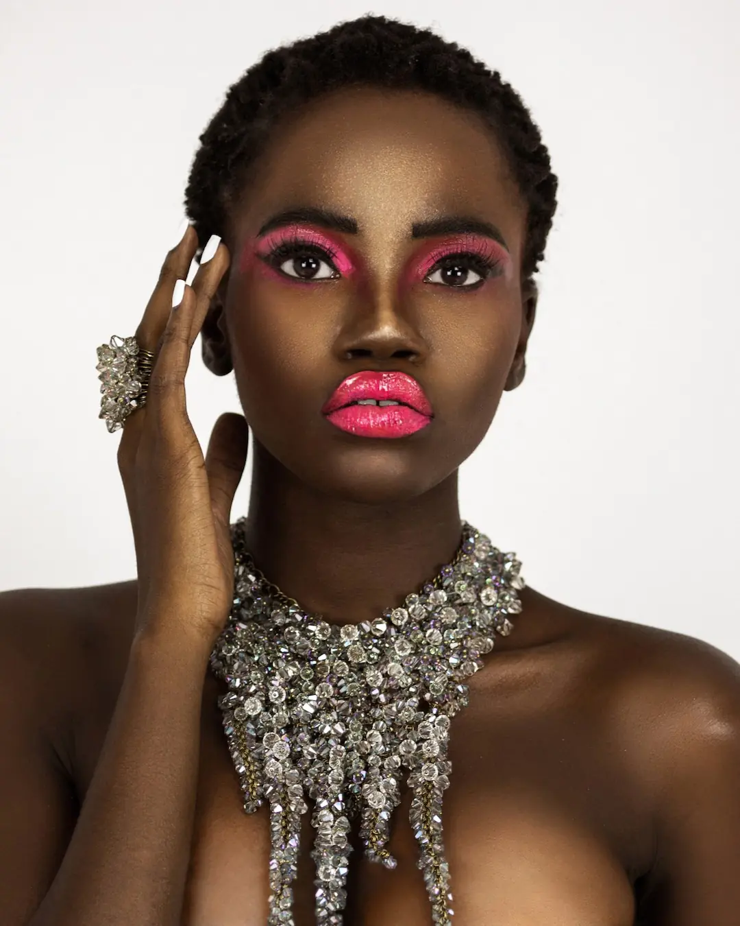 Beauty editorial portrait with vivid pink makeup, white nails and crystal KONPLOTT jewelry