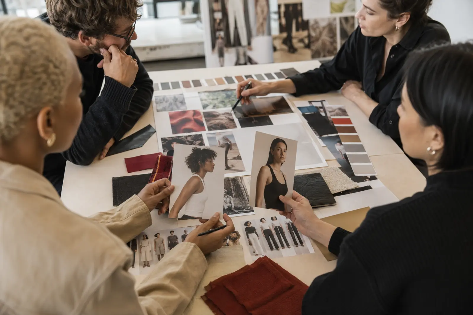 Fashion Campaign Casting: How to Choose the Right Models - Phil Halfmann Creative team comparing fashion campaign casting options with a brand moodboard and product materials