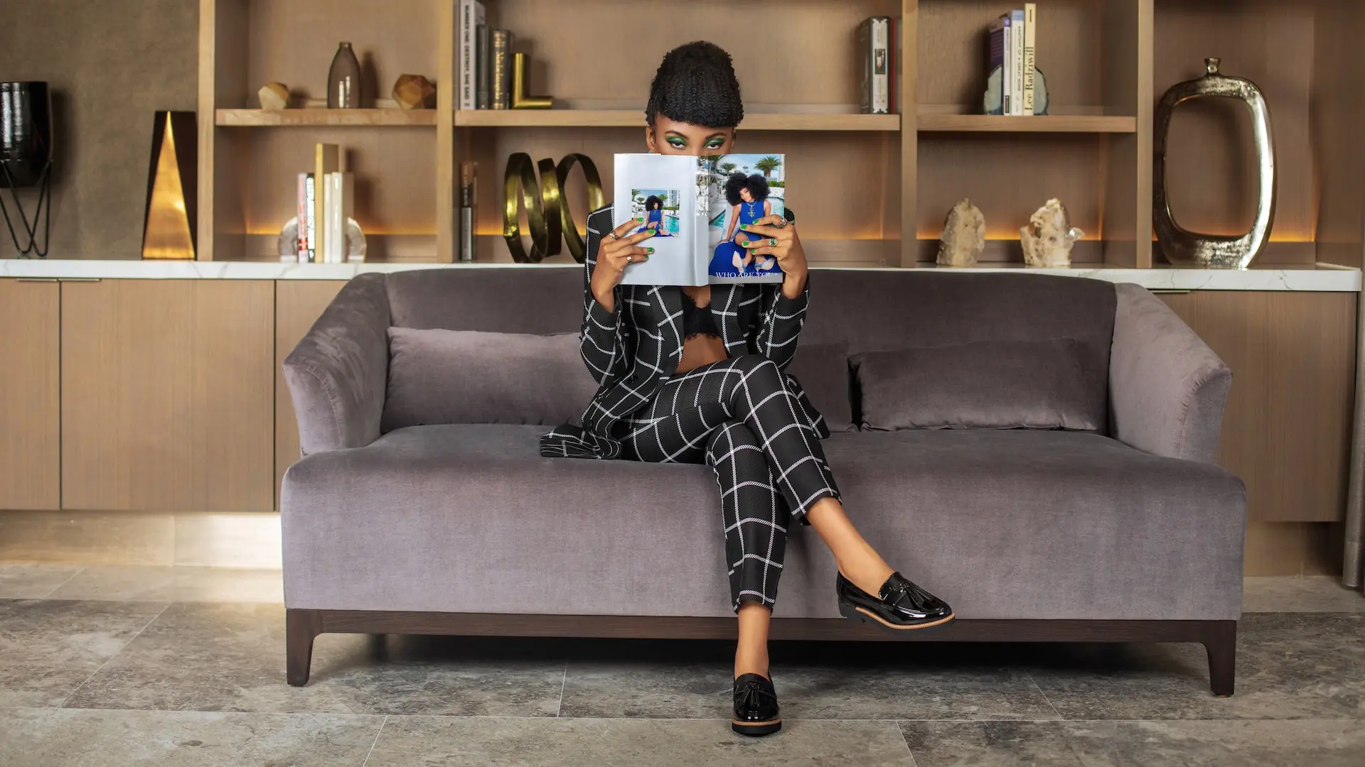 Jordan Kristine Seamon holding a magazine during a fashion magazine content retainer production
