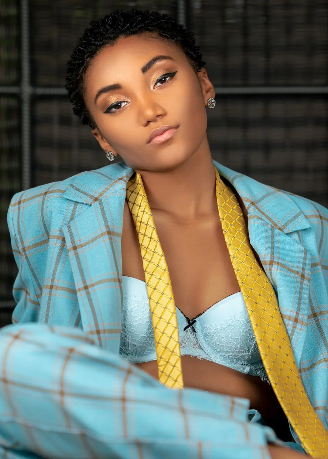 Jordan Kristine Seamon wearing a light blue plaid suit in the Prestige Magazine editorial