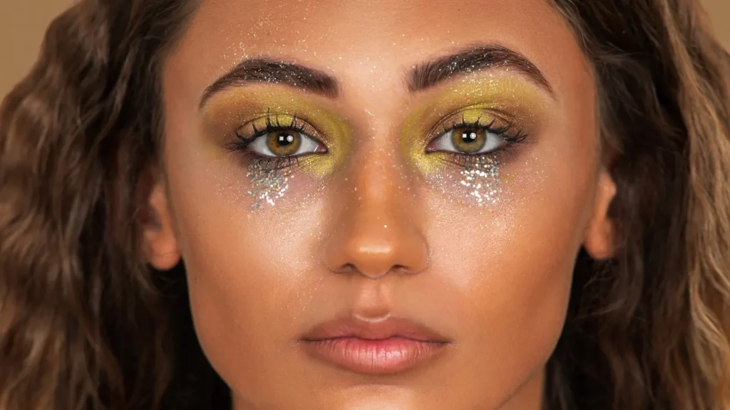 Close-up beauty portrait showing gold eye makeup and glitter detail from the Zalando Beauty scalable photoshoot