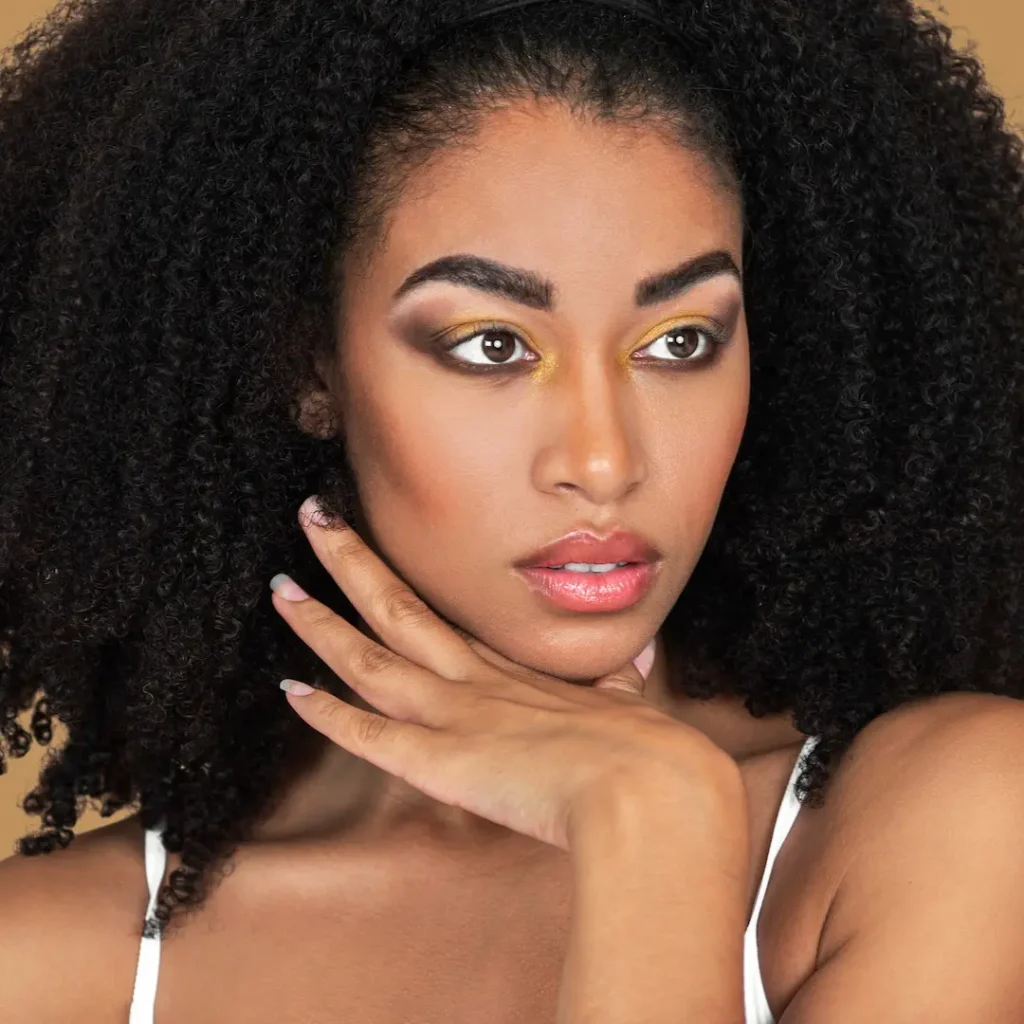 Zalando Beauty: Turning an Inclusive Creative Vision into a Scalable Photoshoot - Phil Halfmann Katherine in a close-up portrait with natural curls and gold eye makeup