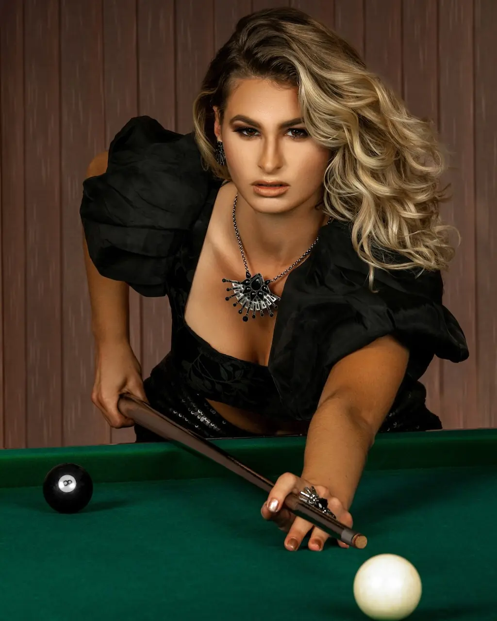 Female model leaning across a billiards table during the Pool Rocker fashion campaign