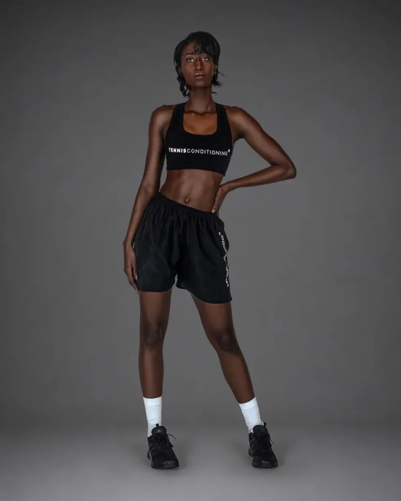 Full-length black StyleConditioning sports-bra campaign look