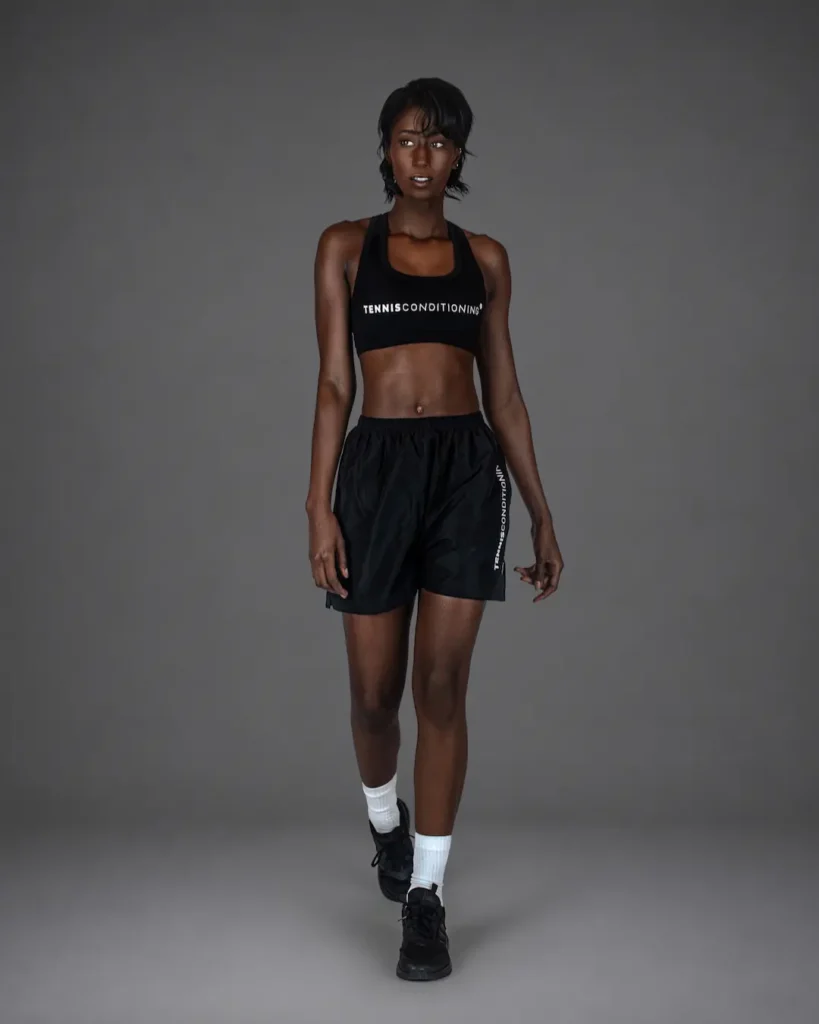 Walking variation of the black StyleConditioning sports-bra campaign look