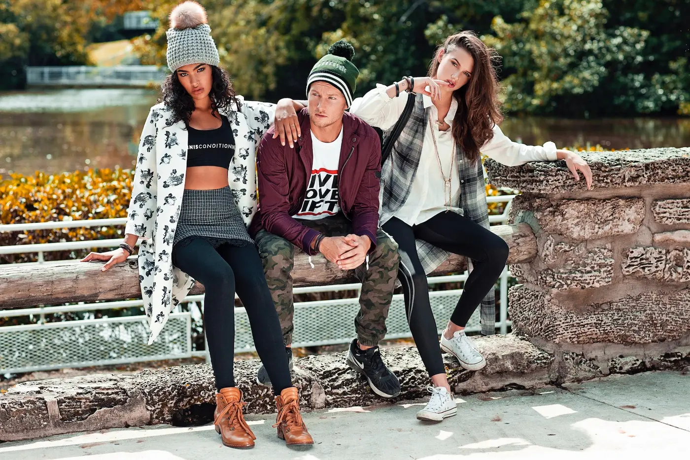 Two models presenting StyleConditioning sports fashion beside a fenced court