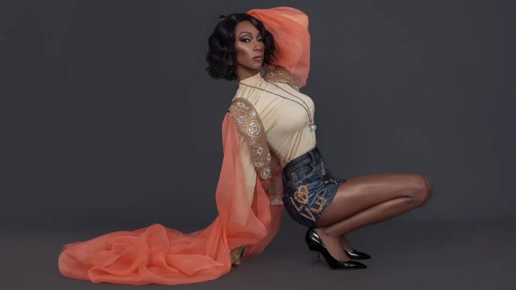 Tanya Marie content infrastructure campaign with a model wearing coral draping and an embellished denim skirt