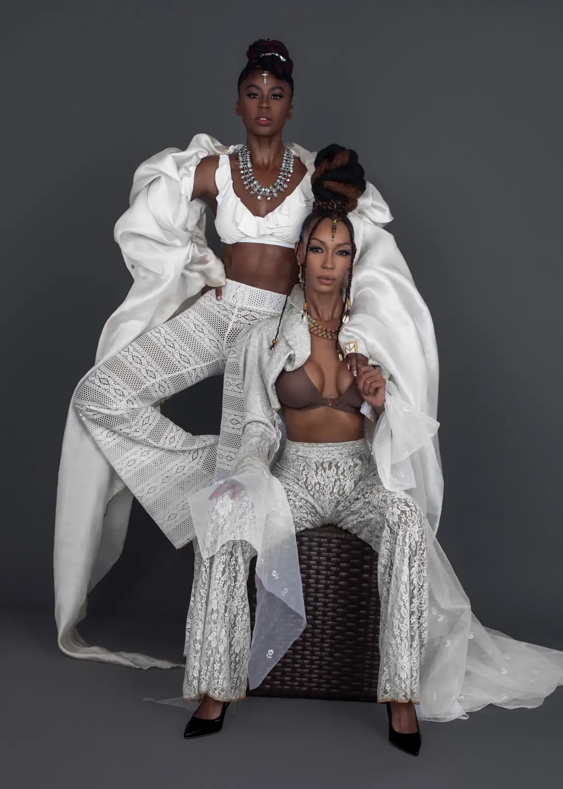 Two models introduce Tanya Marie’s content infrastructure in sculptural white lace and layered tailoring