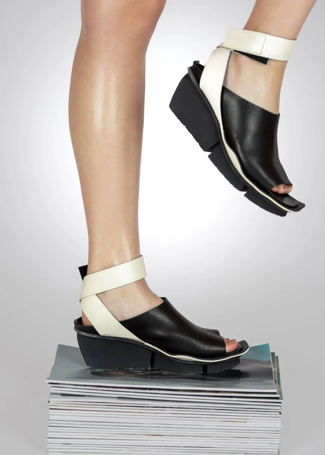 Fashion Campaign Shoot Duration: How Many Hours Do You Need? - Phil Halfmann Low-angle Trippen Shoes campaign setup with black sandals elevated on stacked magazines