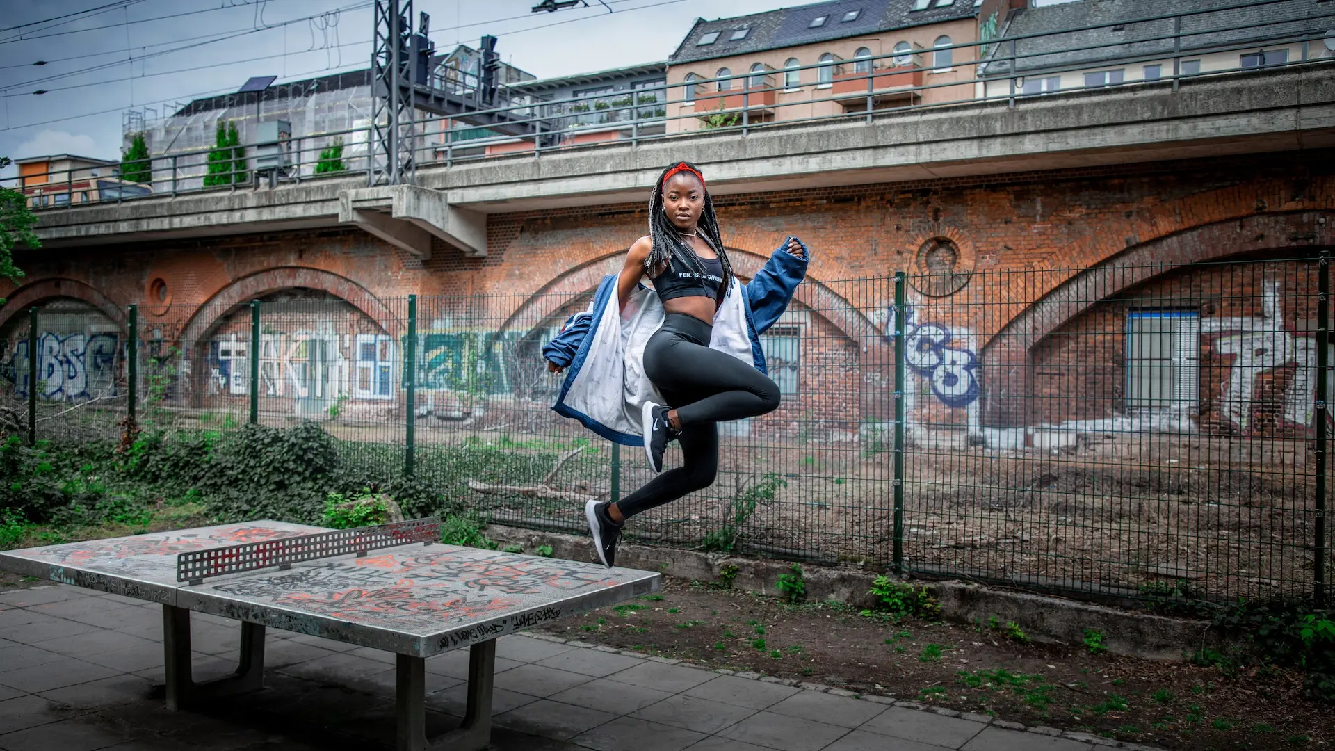Female athlete moving through an urban Berlin sports court
