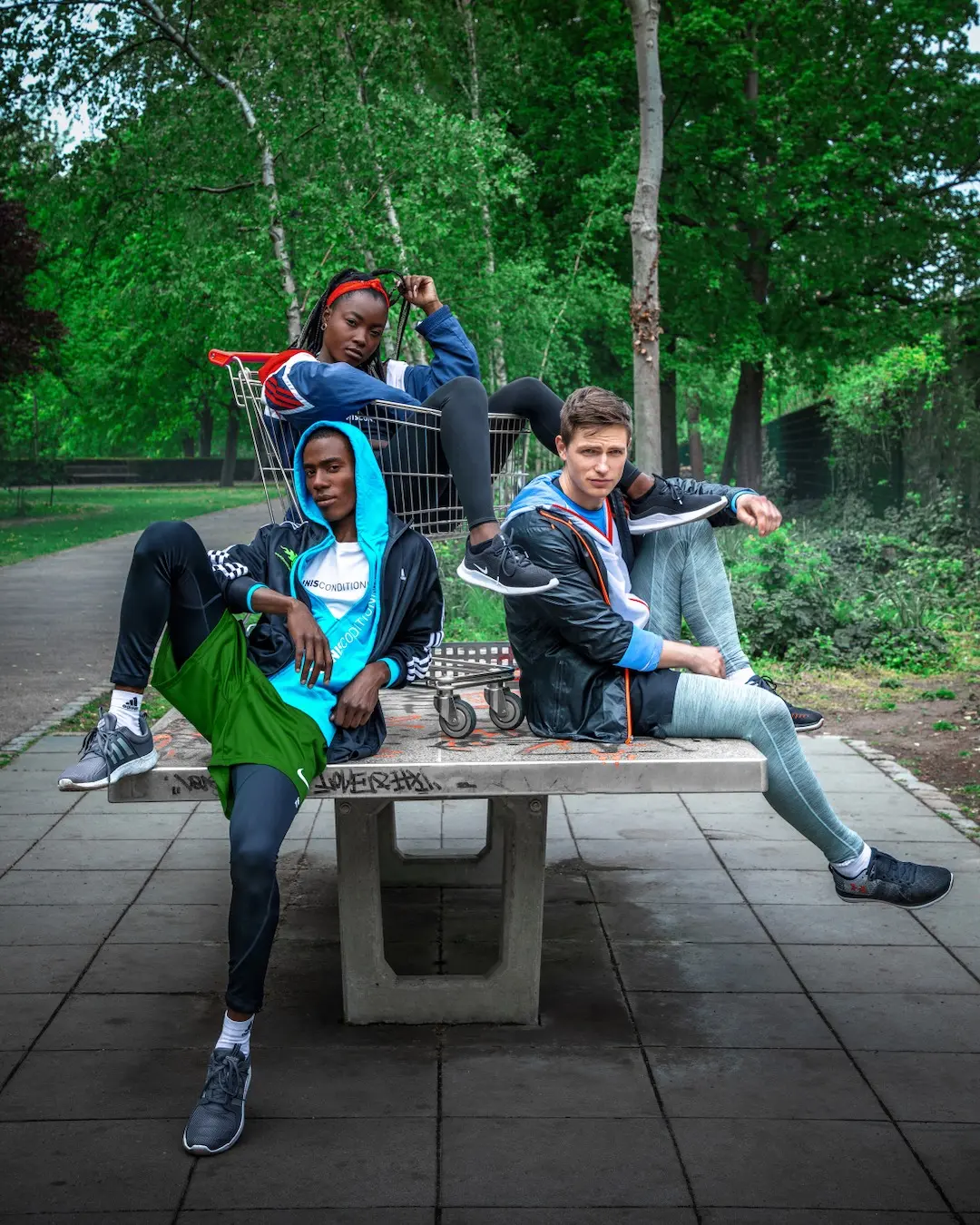 Young athletes relaxing beside an outdoor basketball court in Berlin