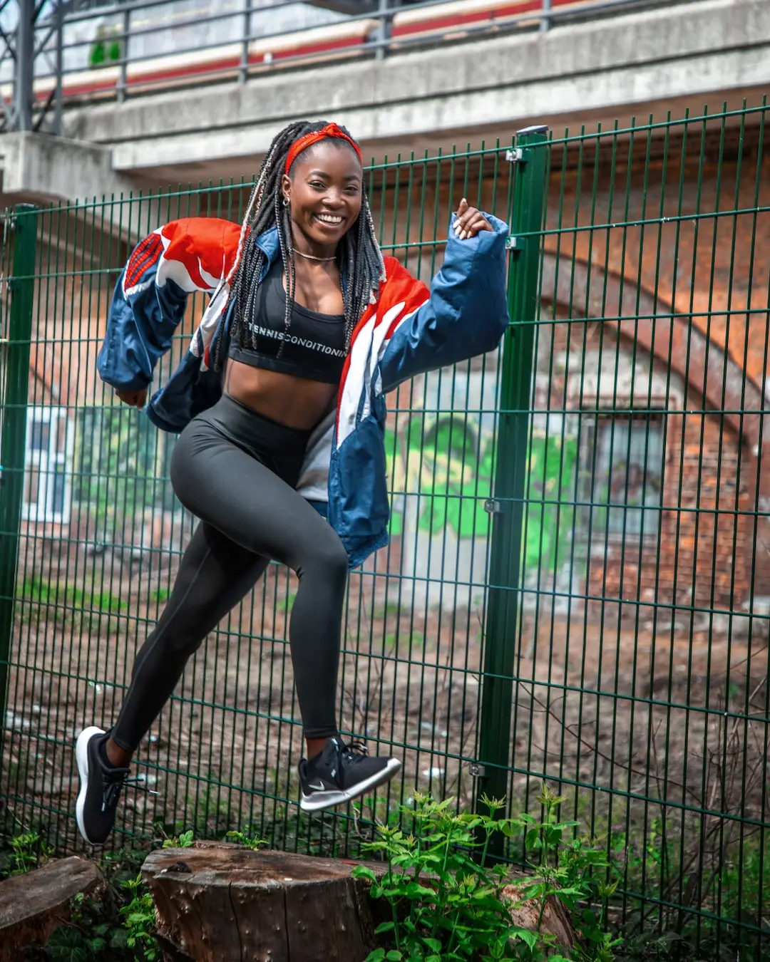 Female athlete captured mid-jump in an urban Berlin sports location
