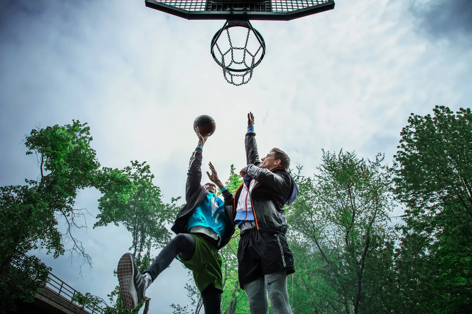 Low-angle basketball action beneath an outdoor hoop in Berlin