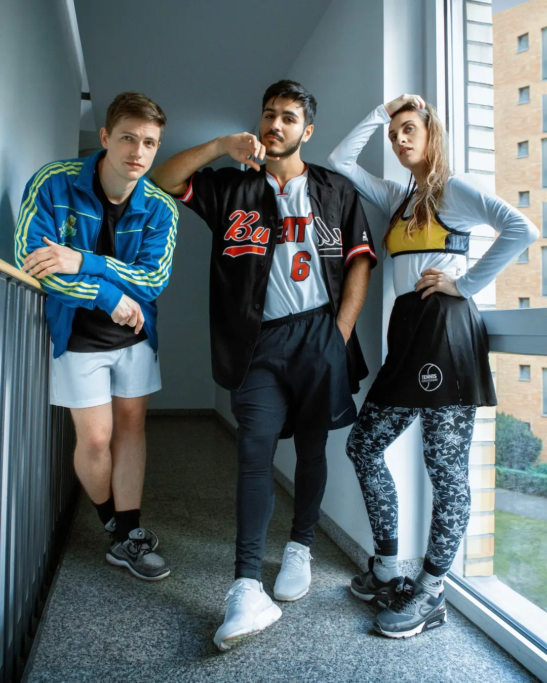 Male athlete wearing layered sports styling in a Berlin interior