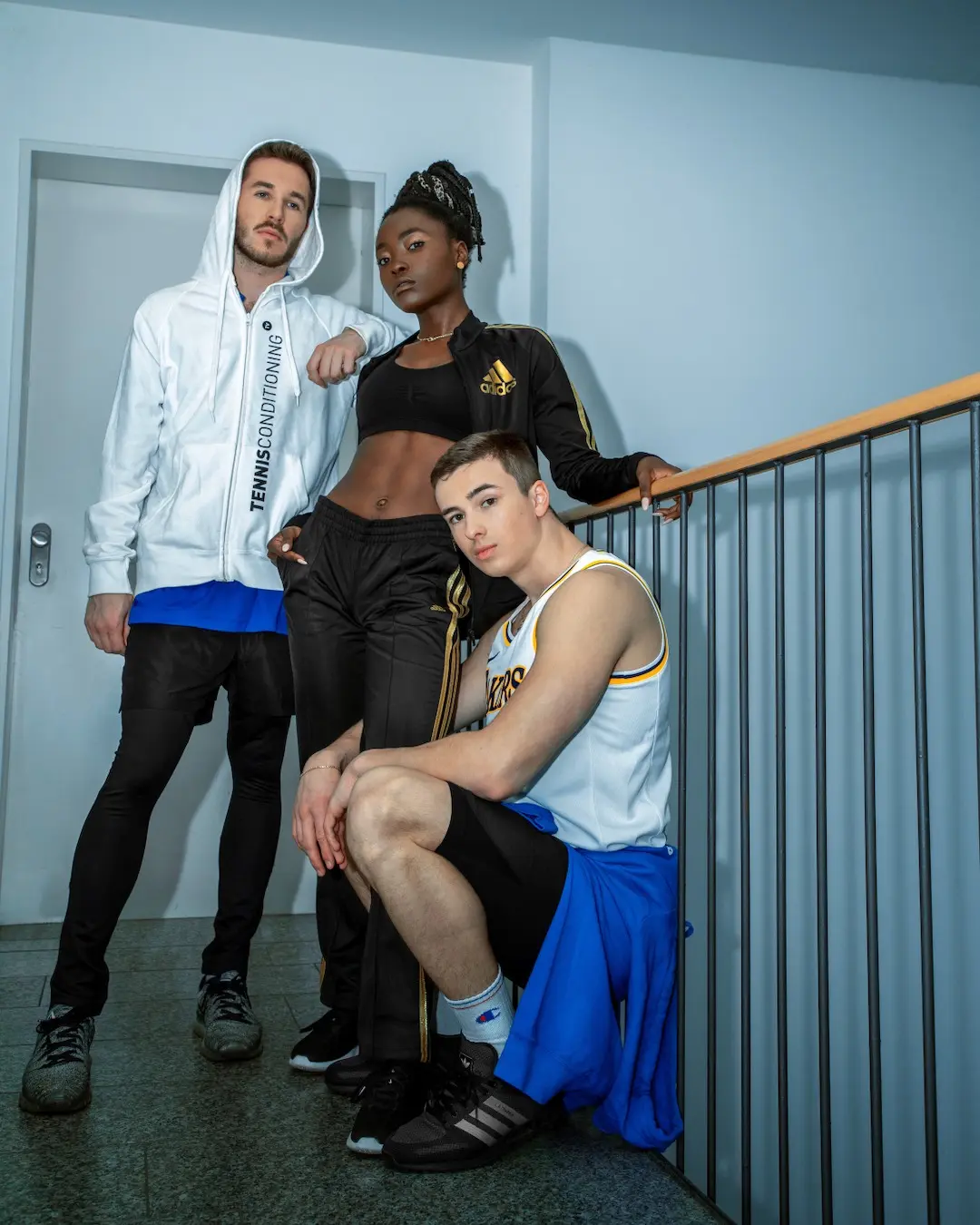 Four-person sports cast portrait beside a bright window in Berlin