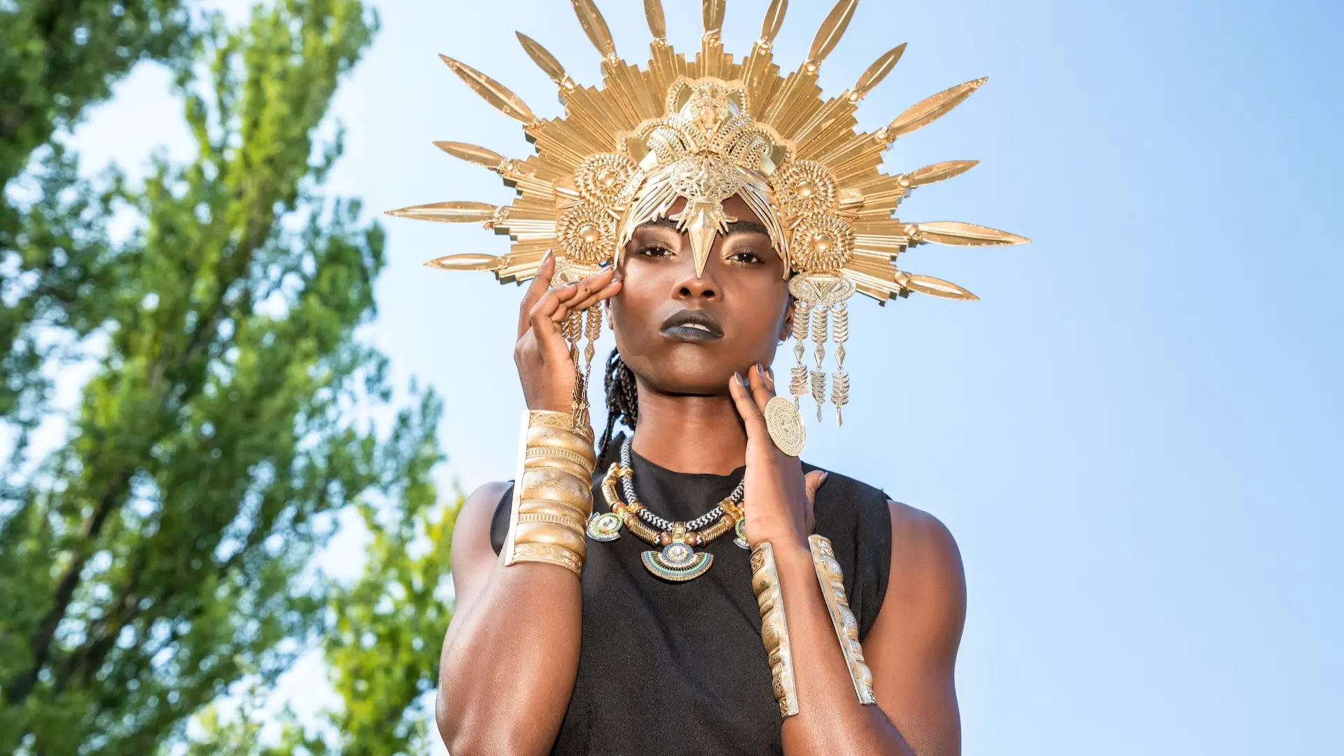 Sculptural Headpieces in Berlin: Building a Cohesive Fashion Editorial Across Six Models - Phil Halfmann Beauty portrait with a gold sunburst headpiece against blue sky