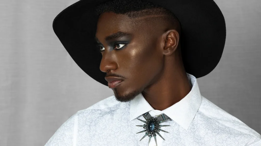 Troy wearing a black hat and white shirt in the Pretty Boy Joy gender-fluid fashion editorial