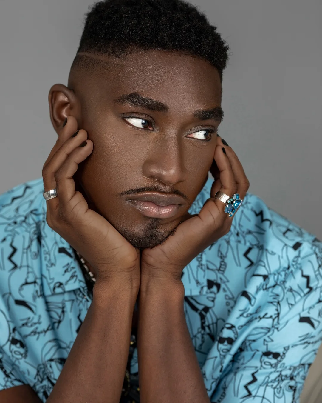 Close beauty portrait of Troy resting his face in his hands