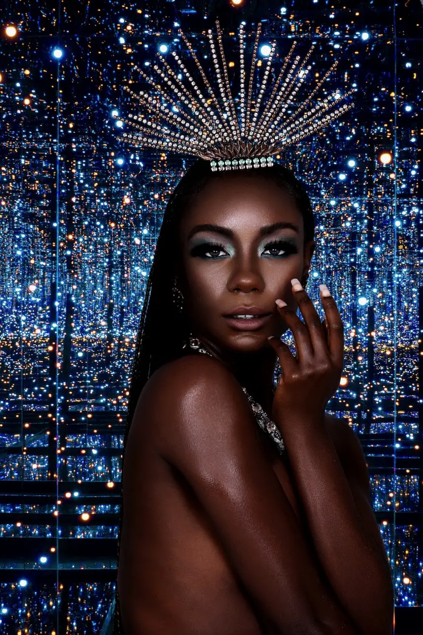 Close beauty portrait with a jeweled headpiece against the blue reflective Colour Me Beautiful set